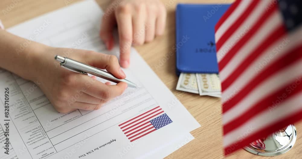 Persons fill out an application for American visa at embassy closeup. Study trip to America