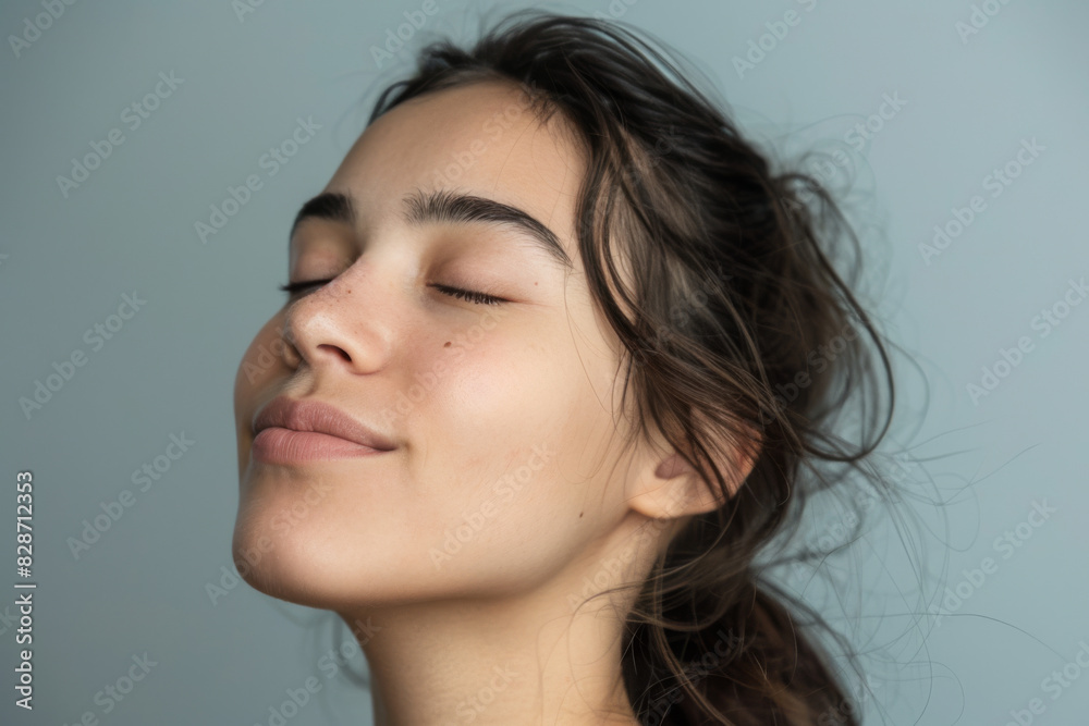 A close up of a woman's face with her eyes closed looking to a side A close up of a woman's face with her eyes closed looking to a side