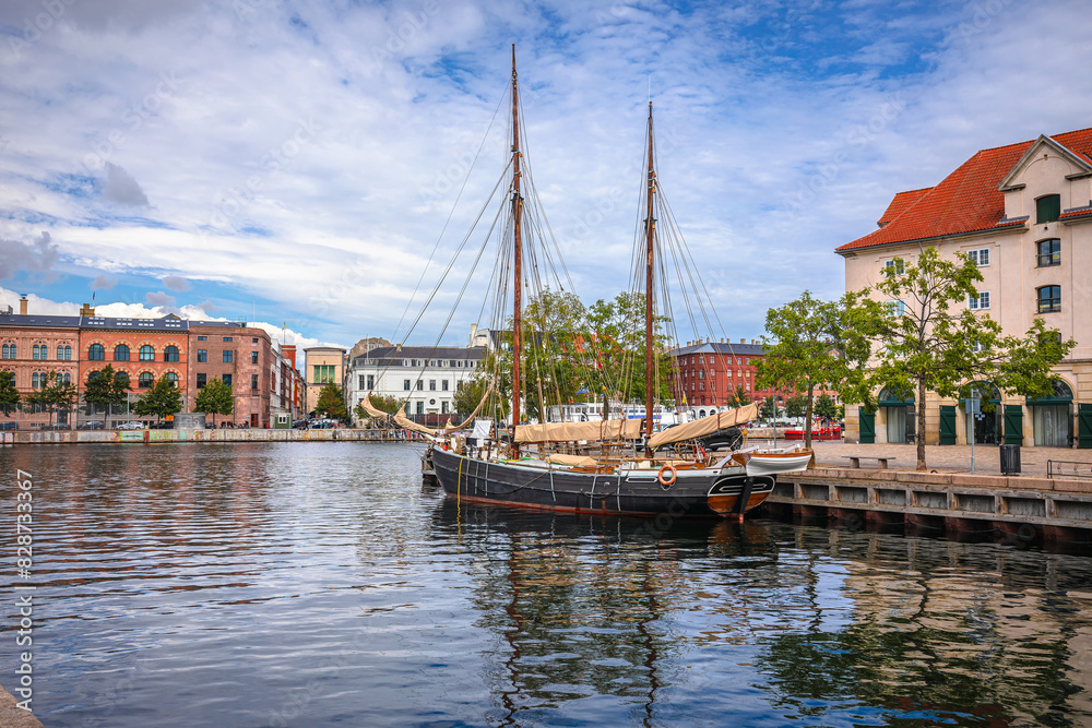 Scenic waterfront and wooden sailboat in Copenhagen waterfront view