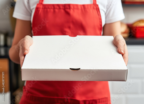 empty white pizza box mock up in a woman hands with red apron