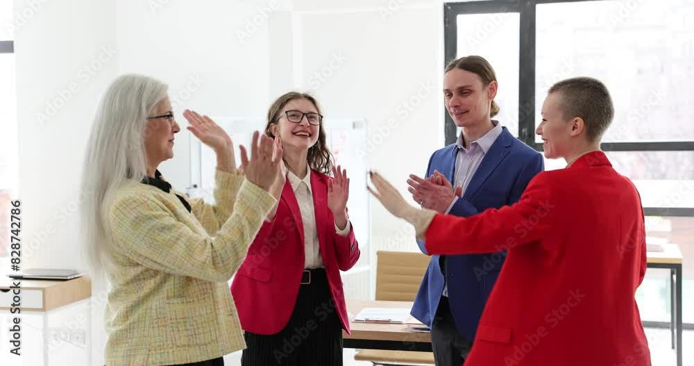 Smiling business people standing in office and giving high five during team building. Successful work and business project Smiling business people standing in office and giving high five during team building. Successful work and business project