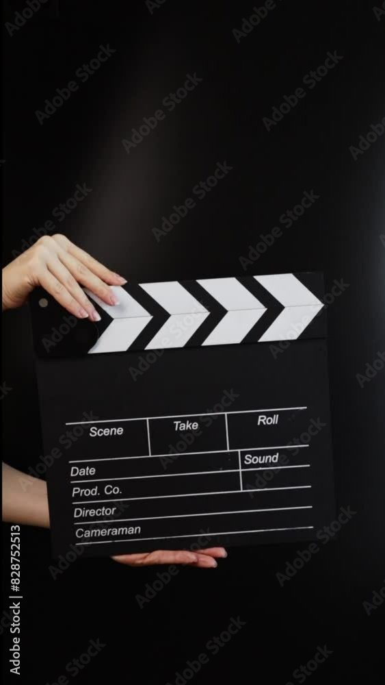 Hands with cinema clapper board, capturing the action, filmmaking in progress.