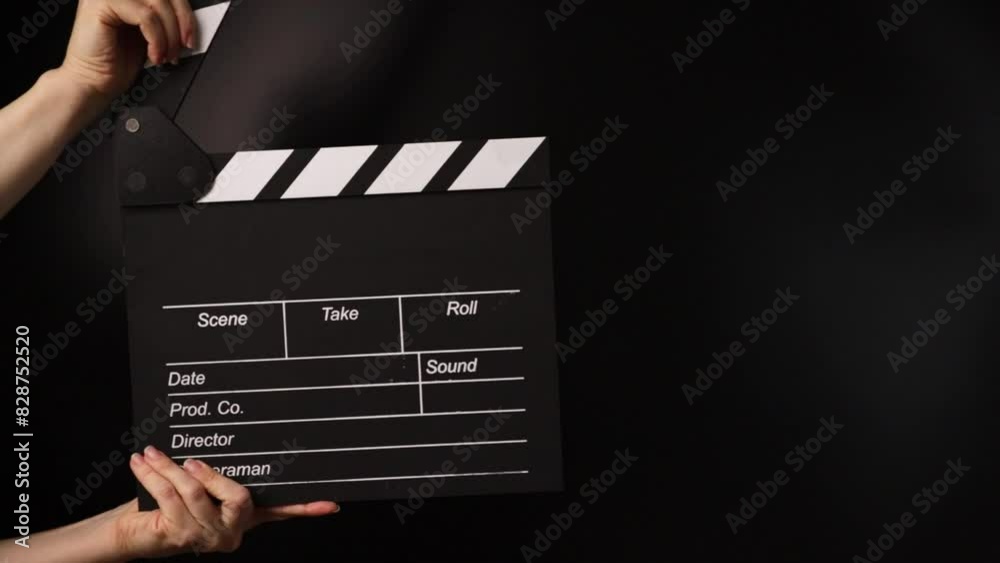 Hands with cinema board, marking the moment, film studio in operation.