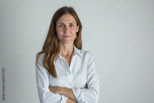 Full length view of a gorgeous school teacher with arms crossed against a white background