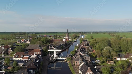 Aerial View: Village Burdaard in Friesland, Netherlands with Windmill and Houses (ID: 828779102)