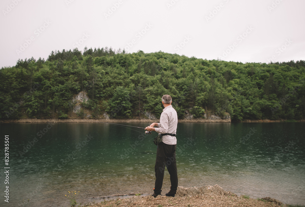 Gray hair man fishing by the lakeshore Gray hair man fishing by the lakeshore