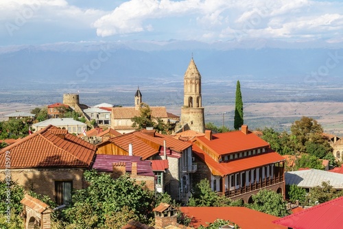 Wallpaper Mural A beautiful landscape of a small village with red-roofed houses and a bell tower with mountain views in the background. Kakheti, Georgia. Torontodigital.ca