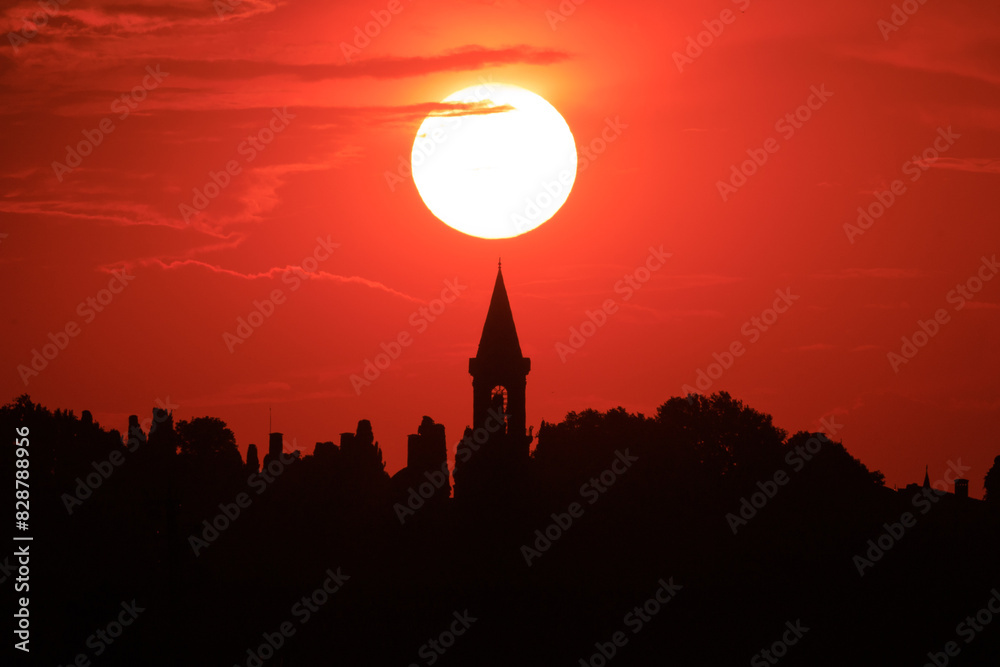 Fototapeta premium Orange sky at sunset in the evening. Silhouette and outlines of the buildings. Evening views of buildings of the city of Istanbul.