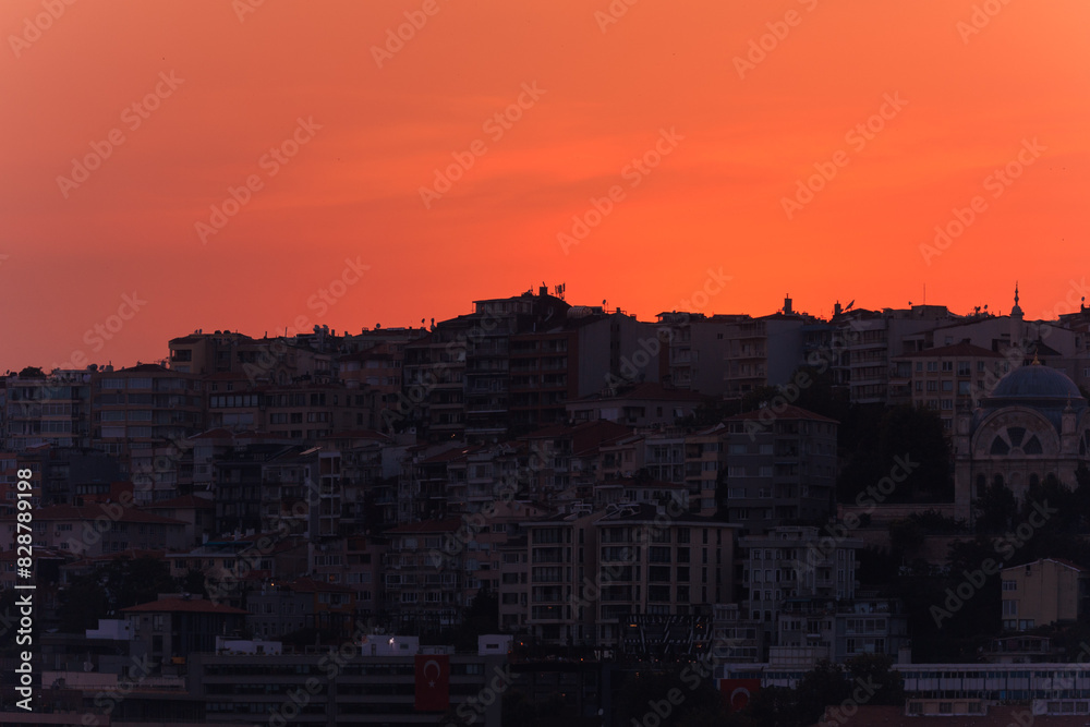 Orange sky at sunset in the evening. Silhouette and outlines of the buildings. Evening views of buildings of the city of Istanbul. Orange sky at sunset in the evening. Silhouette and outlines of the buildings. Evening views of buildings of the city of Istanbul.