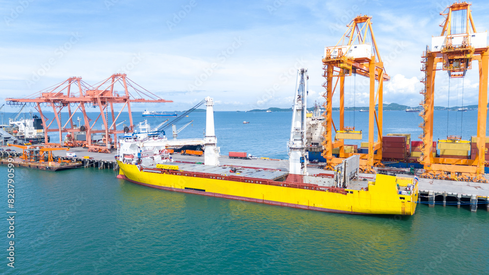 Crane loading box container to cargo ship at commercial dock port. Shipyard Cargo Container Sea Port Freight forwarding service logistics and transportation. International Shipping Crane loading box container to cargo ship at commercial dock port. Shipyard Cargo Container Sea Port Freight forwarding service logistics and transportation. International Shipping