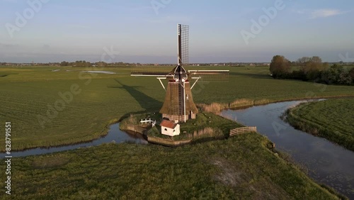 Aerial View: Historic Windmill in Wanswert, Friesland, Netherlands with Surrounding Farmland photo