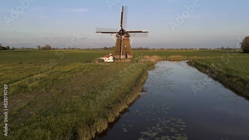 Aerial View: Historic Windmill in Wanswert, Friesland, Netherlands with Surrounding Farmland (ID: 828791769)