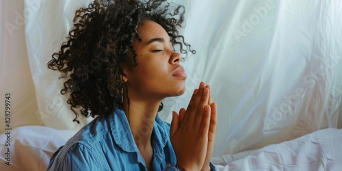 Nighttime prayer with black woman in bedroom for spirituality, religion, or Christianity. Domestic forgiveness, belief, and thankfulness with women and prayer for worship, peace, or communication photo