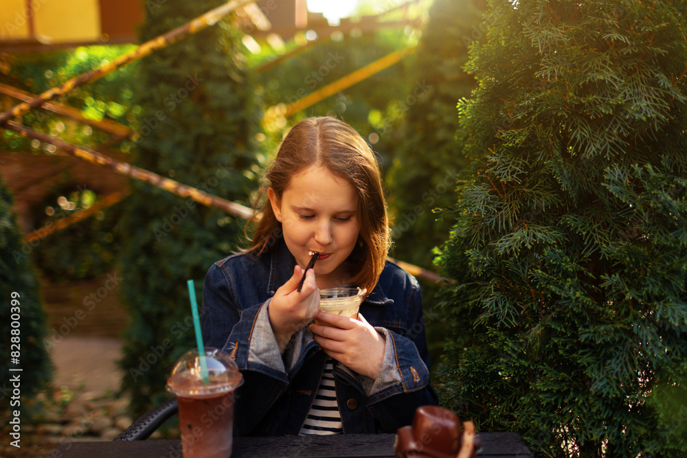 Fototapeta premium cute girl sitting in an outdoor cafe