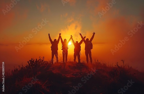 silhouettes of group of friends standing on a hill in the middle of the sunrise