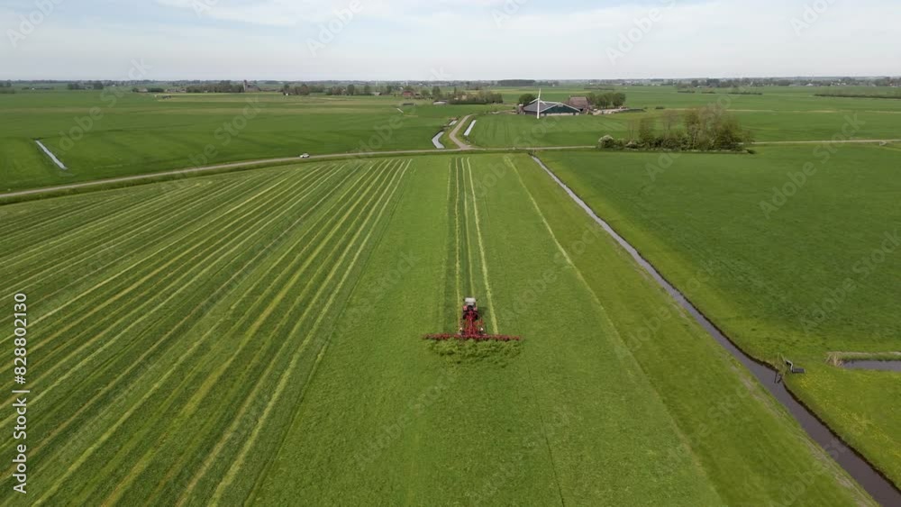 Harvesting Season: Aerial Shot of Tractor Shaking Grass on Farmland Harvesting Season: Aerial Shot of Tractor Shaking Grass on Farmland