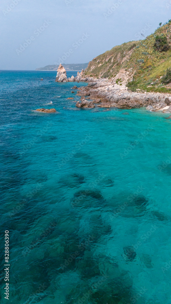 Fototapeta premium Aerial view of Michelino beach in Parghelia, Tropea. Calabria. Italy. Transparent sea and luxuriant nature. The most beautiful beach in Europe