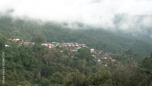 Landscape Green nature of Green Mountain with Traditional Thai House Little village seen at Doi Sakad Pua  Nan Thailand in Rainy Season in the morning  photo