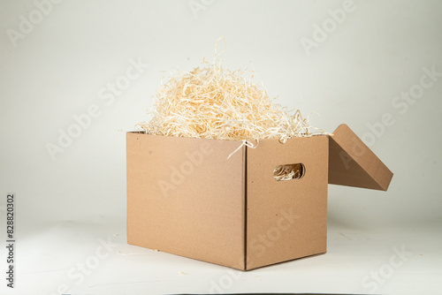 Cardboard box with wood filling on a white background