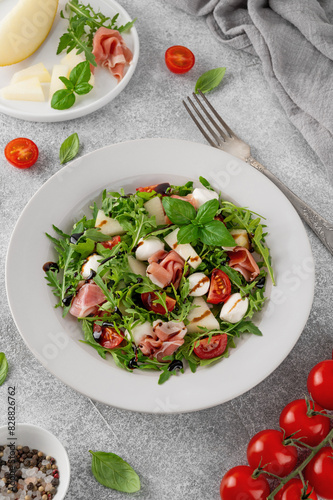 Wallpaper Mural Fresh summer salad with arugula, melon, prosciutto and mozzarella cheese on concrete background, Healthy food. Top view. Torontodigital.ca