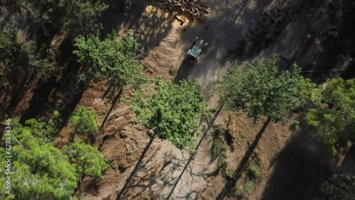 Aerial video above a tactor pulling a tree in Ein Shosfit National Park, Israel photo