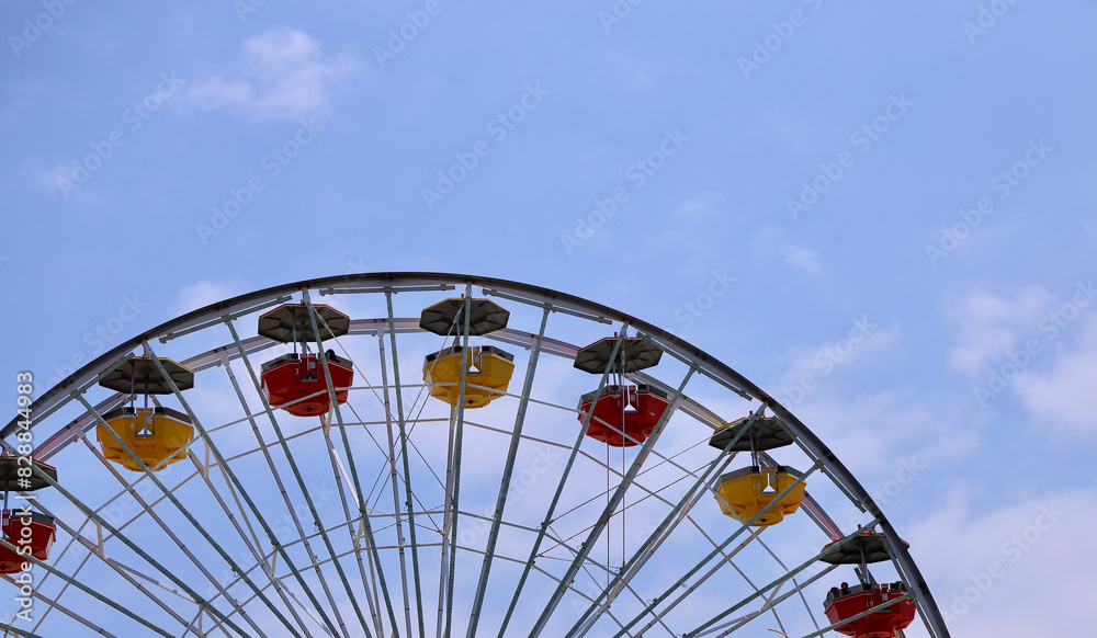 ferris wheel against a light blue sky ferris wheel against a light blue sky
