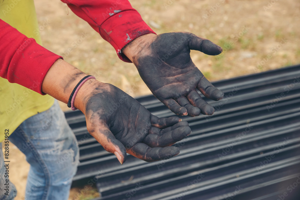 Close Up of dirty stained palm hand, black lubricant oil. Worker hand open the palm at construction site. Close Up of dirty stained palm hand, black lubricant oil. Worker hand open the palm at construction site.