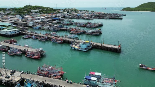 4K Aerial view of fishing boats parked at bay pier in Thailand photo