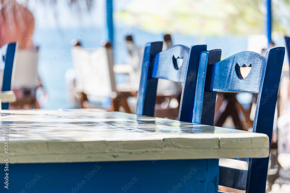 Beautiful wooden blue chairs in a beach restaurant