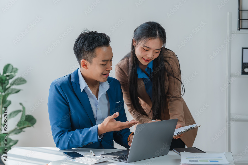 Asian business team discussing over laptop in a corporate. Group collaboration and teamwork concept. Asian business team discussing over laptop in a corporate. Group collaboration and teamwork concept.
