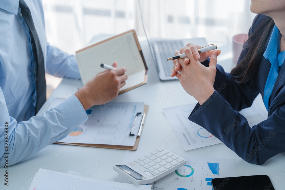 Asian business team discussing over laptop in a corporate. Group collaboration and teamwork concept. Asian business team discussing over laptop in a corporate. Group collaboration and teamwork concept.