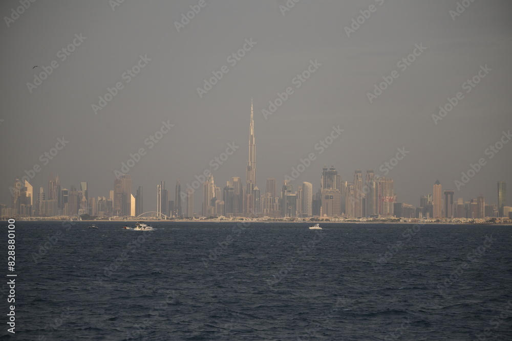 sailboats sail near the skyline of dubai with buildings in the background sailboats sail near the skyline of dubai with buildings in the background