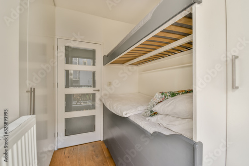 Space-saving bedroom design with elevated bed and wooden floor