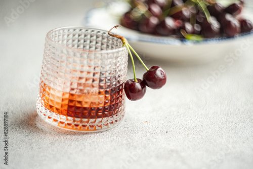 Elegant Cherry Liqueur in Textured Glass with Fresh Berries photo