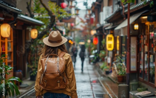 A woman with a backpack walking down a street in the old town