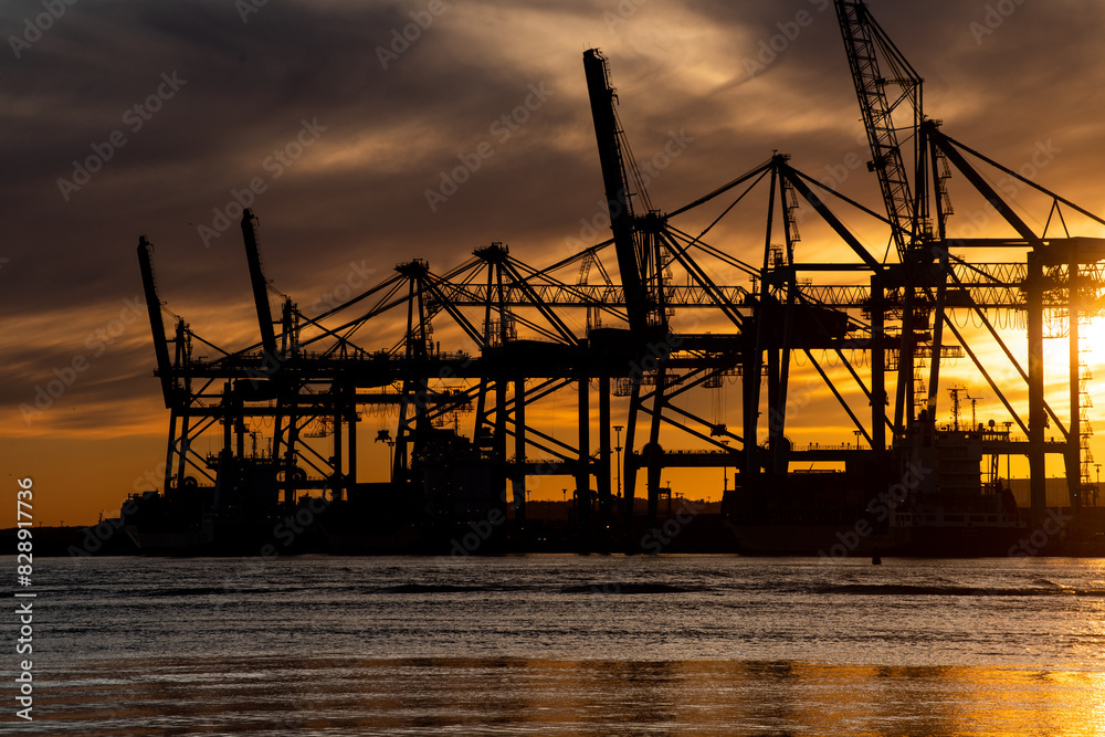 Silhouettes of ship to shore cranes at sunset.. Silhouettes of ship to shore cranes at sunset..