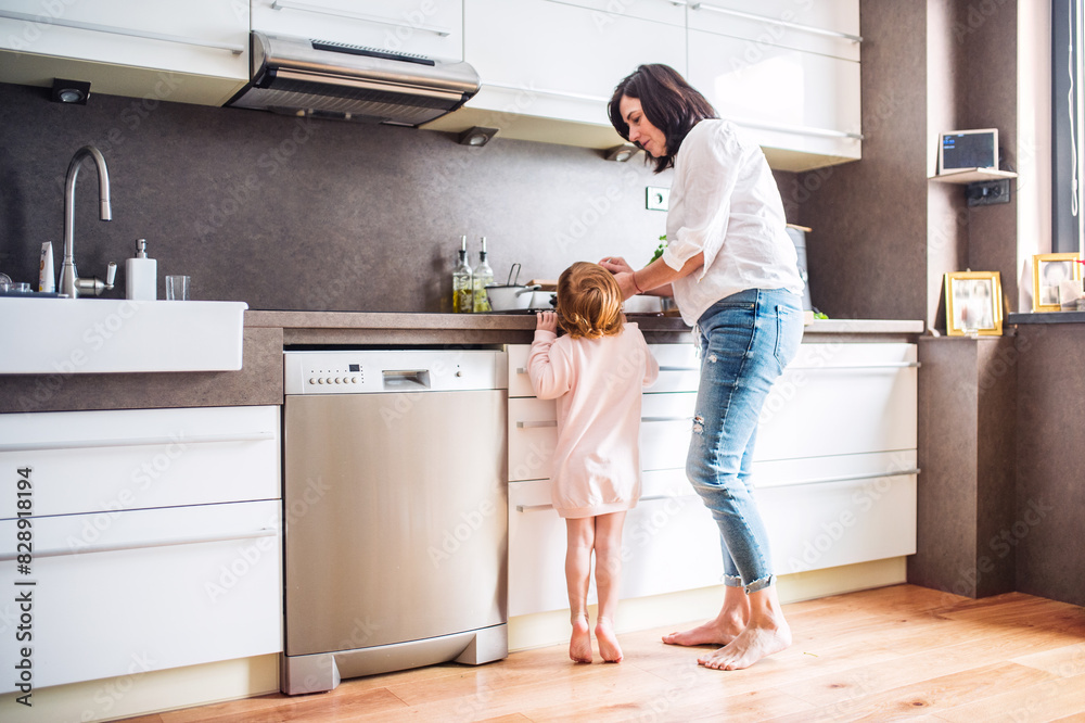 Grandma takes care of the grandchildren while parents are at work, spending time in kitchen, cooking together and having fun. Grandma takes care of the grandchildren while parents are at work, spending time in kitchen, cooking together and having fun.