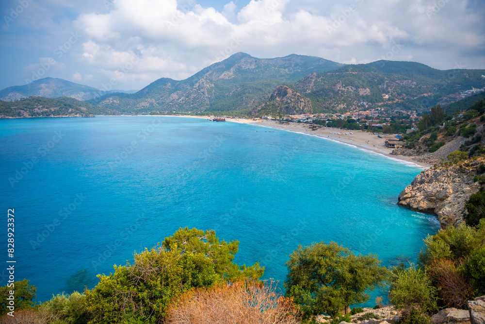 Aerial view of Oludeniz beach with people and boats in the morning, Coastline next to Fethiye, Turkey