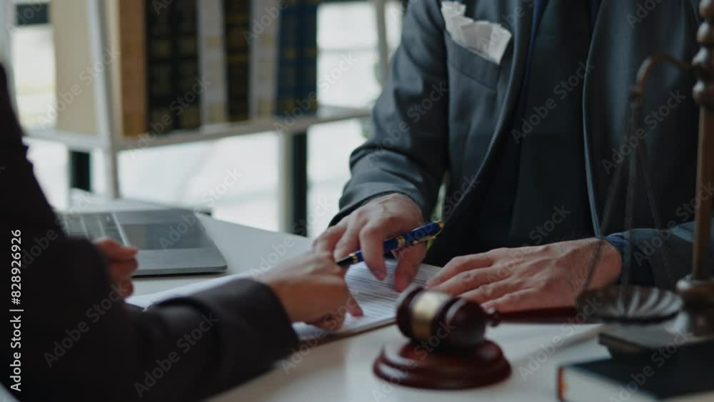Lawyers explain and discuss matters of law and contract to clients and gavel hammer. Lawyers explain and discuss matters of law and contract to clients and gavel hammer.