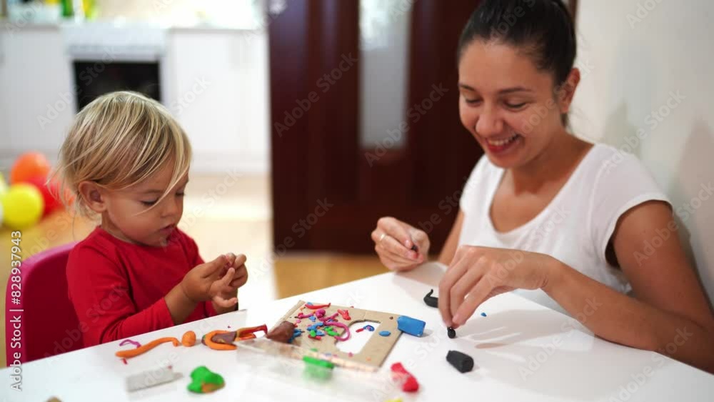 Smiling mother and little girl sculpt figurines from plasticine. High quality 4k footage Smiling mother and little girl sculpt figurines from plasticine. High quality 4k footage