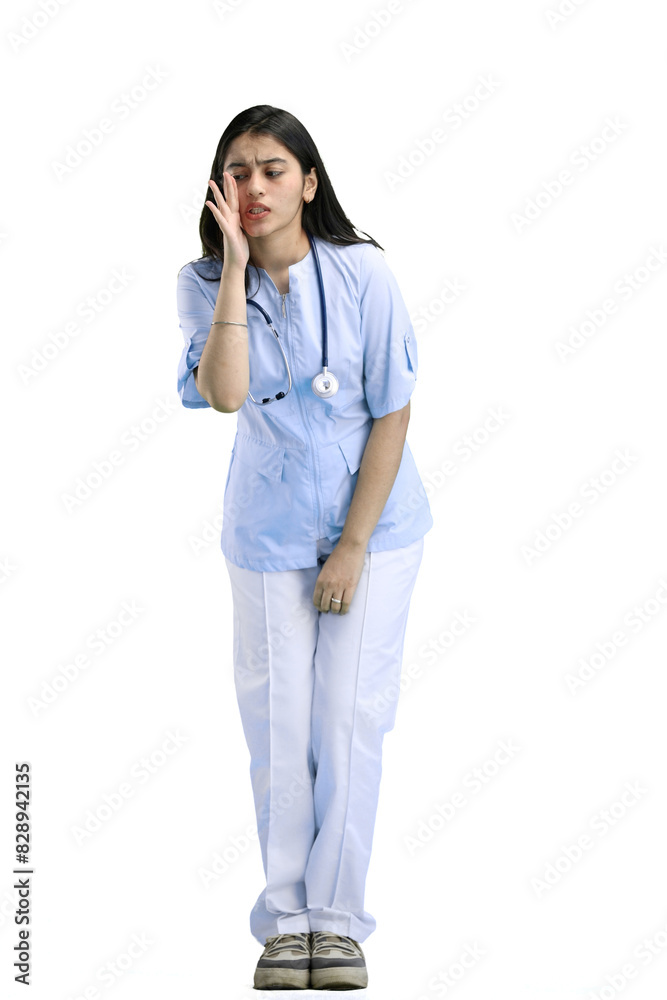 A woman doctor, full-length, on a white background, tells a secret