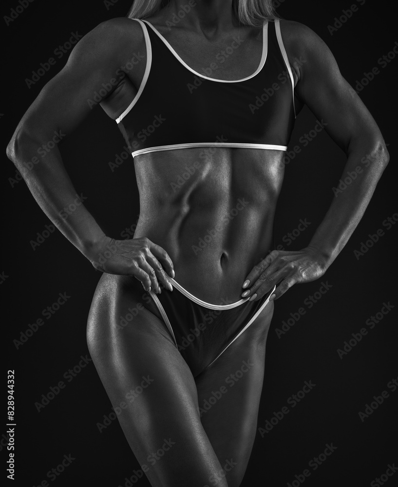 Fototapeta premium A slender swarthy Bodybuilder girl in red sportswear on a white background. Healthy lifestyle, sport and diet.