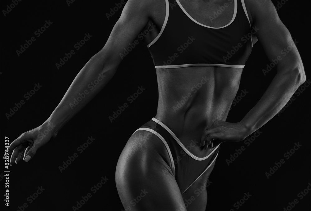Fototapeta premium A slender swarthy Bodybuilder girl in red sportswear on a white background. Healthy lifestyle, sport and diet.