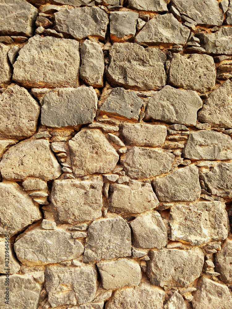 Irregular stone wall background. Architecture and construction. Decorative brick fence wall made of rock and cement. Irregular stone wall background. Architecture and construction. Decorative brick fence wall made of rock and cement.