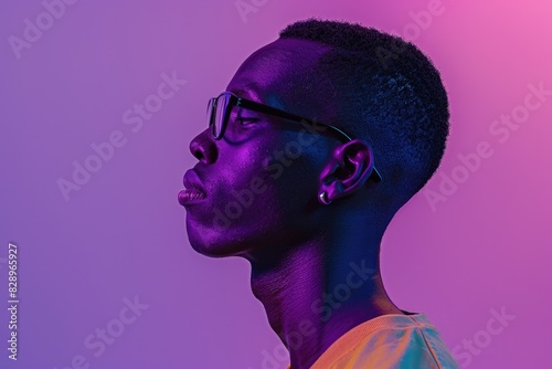 Portrait of young African man in glasses with neon lights