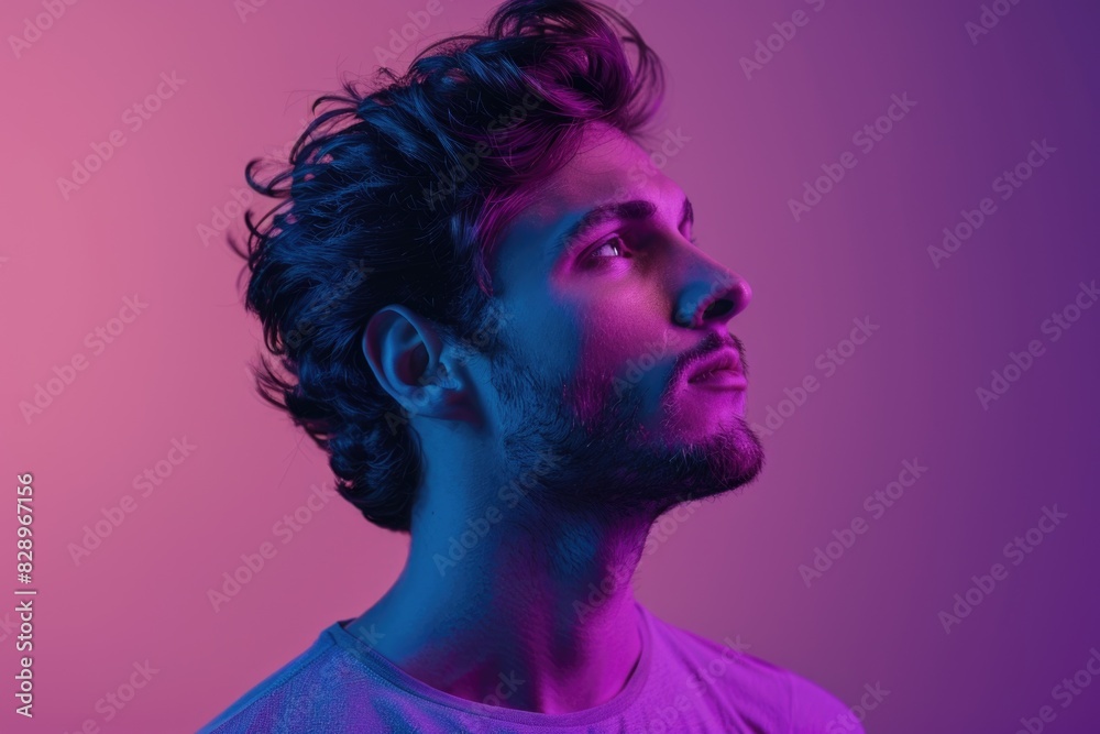Handsome man in casual clothes showing emotions in neon light. Handsome man in casual clothes showing emotions in neon light.