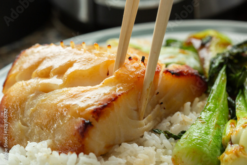 Eating miso glazed broiled black cod butterfish photo
