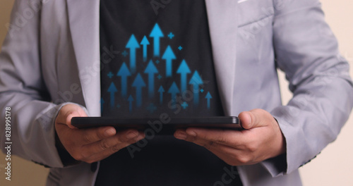 Interest rates and dividends Businessman holds arrow and percentage icon with graph indicators for investment growth. business financial investment Business growth, revenue, marketing and profits