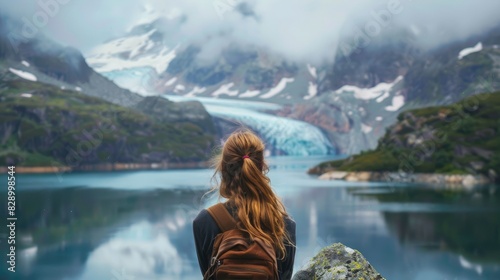 Fototapeta Naklejka Na Ścianę i Meble -  A girl amidst stunning mountains and a lake