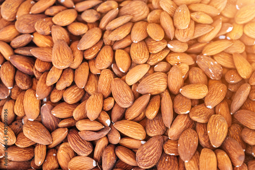 background with orange peeled almond kernels on the market counter close-up background with orange peeled almond kernels on the market counter close-up